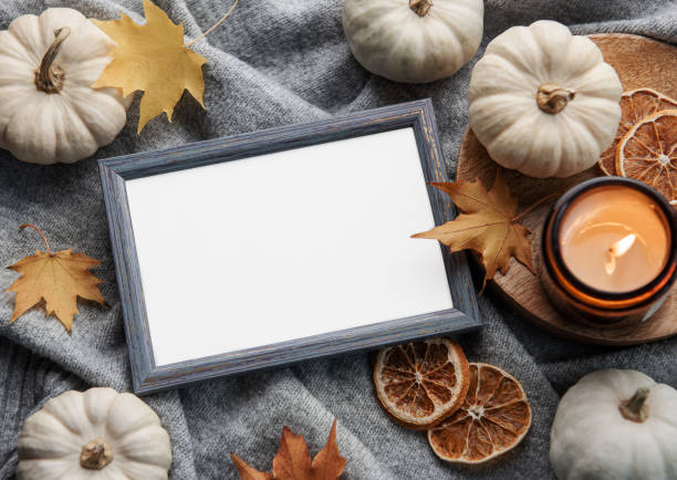 istock Autumn composition. Photo frame, pumpkins, dried leaves 1435220703