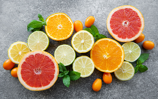 Overhead view of multicolored fresh ripe organic fruits shot on white background. The composition includes mango, orange, strawberry, blueberry, kiwi, peach, grape, watermelon, banana, papaya, apple, pear, fig, lime and lemon. High resolution 42Mp studio digital capture taken with SONY A7rII and Zeiss Batis 40mm F2.0 CF lens