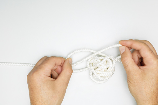 Male hands with rope knot. Psychotherapy concept of solving problems is easy.  solution problems.