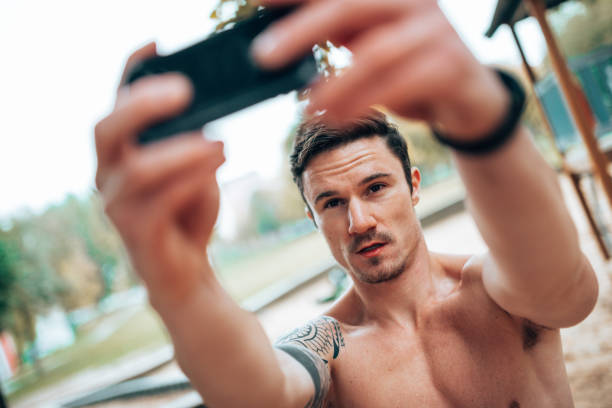 istock muscle man take a selfie outdoor 1435228059