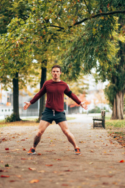 istock fitness man doing stretching in the park 1435228186