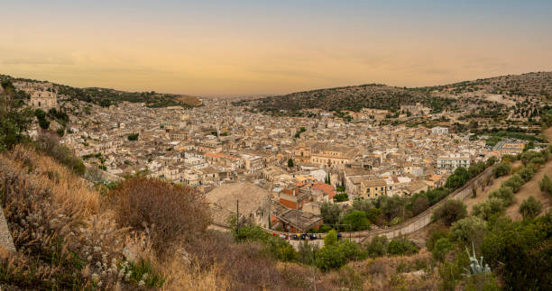 extra wide aerial landscape of scicli with beautiful historic buildings in the baroque style at sunset - scicli imagens e fotografias de stock