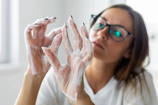 Photo of Woman obsessively washing her hands