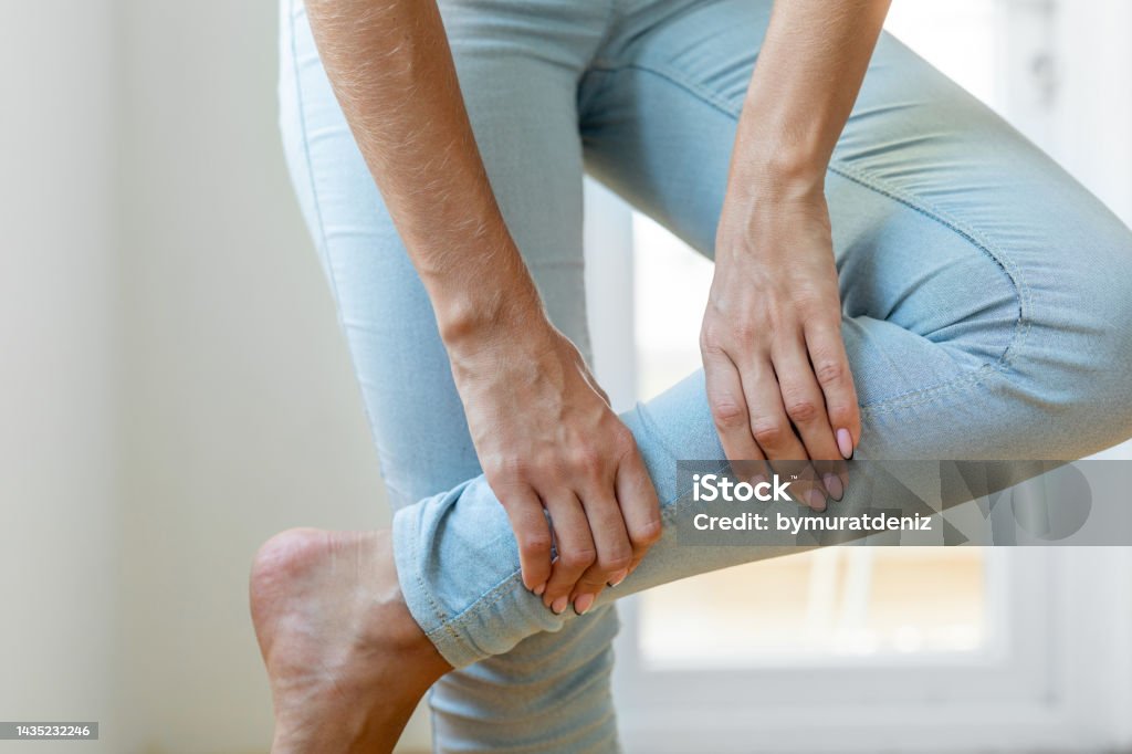 Pain in calf muscle of the woman Leg Stock Photo