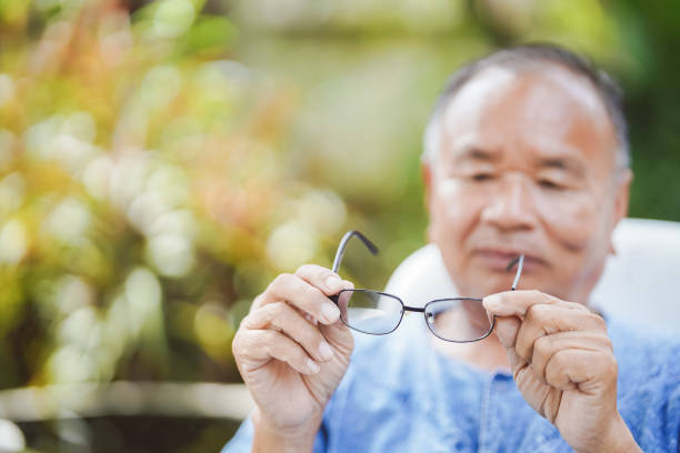 istock The old man raised his glasses and looked before putting them on. Selective focus. 1435232354