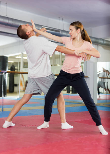 Woman learning chin strike move during self-defense training European woman learning chin strike move during self-defense training. self defense stock pictures, royalty-free photos & images