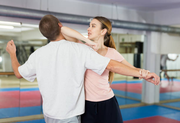 istock Woman performing elbow strike during self-defence training 1435239470
