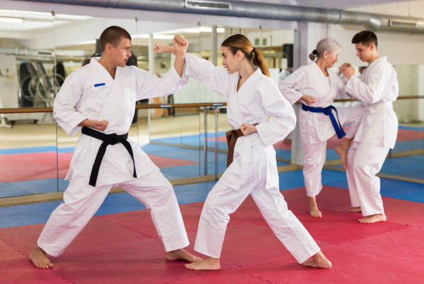 istock Girl in kimono practicing martial arts techniques paired with trainer 1435239494