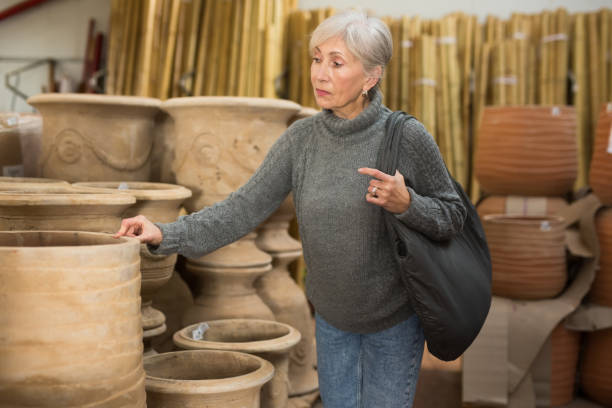 istock Senior woman choosing earthenware crockery in store 1435239634