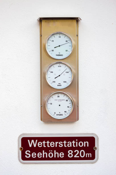 weather station hanging on stone wall