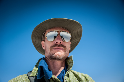 Man wearing sunglasses in the desert.