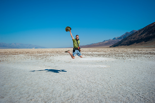 Man Jumping in Death Valley desert.