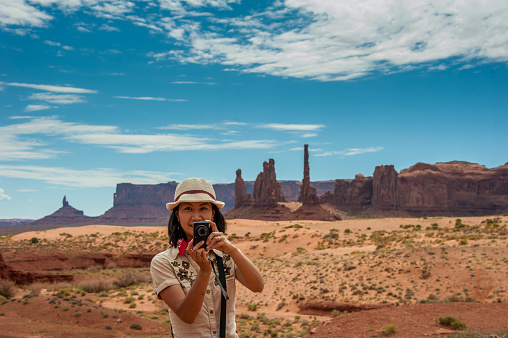 Japanese tourist taking a picture in Monument Valley, Utah.