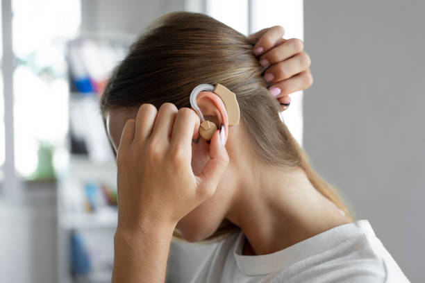 Woman wearing a hearing aid stock photo