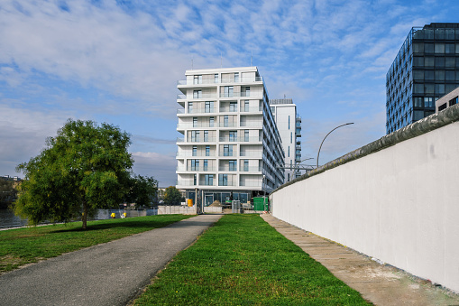 low angle view on modern cubic white residential houses in berlin alongside the spree river in friedrichshain