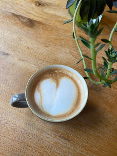 istock A cup of cappuccino on a wooden table. 1435245853