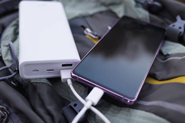 istock Smartphone with power bank on the travel backpack 1435245880