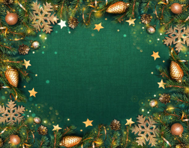 Spruce, fir branches, golden colored decorations on dark green background. Frame border. Christmas New Year composition background greeting card. Christmas lights. Space for text. Banner.