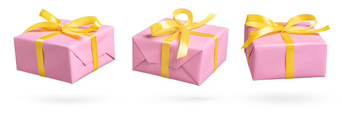 Set of pink gift box with yellow ribbon on white. This file is cleaned and retouched.