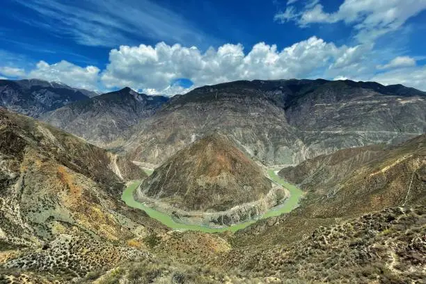 An aerial view of rocky mountains with the Yangtze river on a bright sunny day