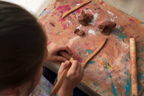 Children hands molding clay