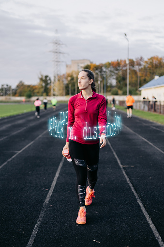A digital technologies shows a result of running of a woman on the running track. Sports and technologies.