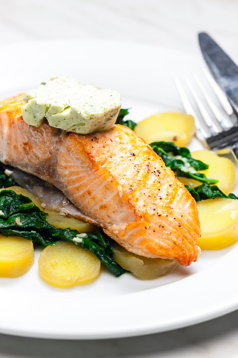 baked salmon with spinach leaves and potatoes