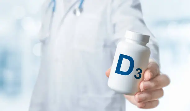 Doctor recommends taking supplement D. Essential vitamins and minerals for humans. doctor gives vitamin D3. D alphabet Bottles with vitamins and dietary supplement. D3 Vitamin - Health Concept.