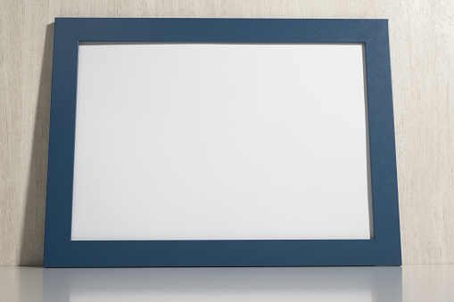 Horizontal photo frame mockup on white wall. blank diploma frame on white wooden wall background. Picture frame mockup. blank diploma frame on white wall background. Size a3, a4, copy space