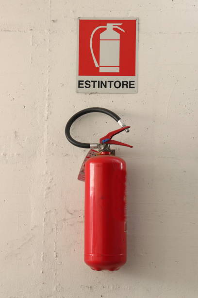 istock Red fire extinguisher hanging on the wall inside a garage. 1435256250