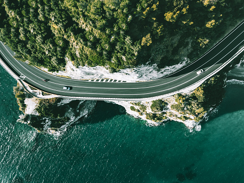 Aerial view of road going along  ocean or sea in Italy. Drone photography from above