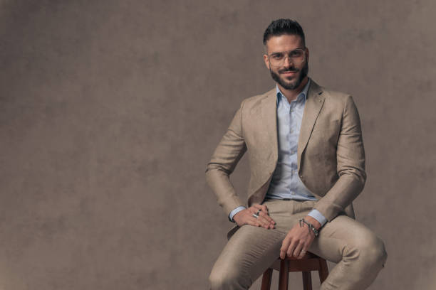 istock handsome happy guy in suit with open collar shirt smiling 1435258378