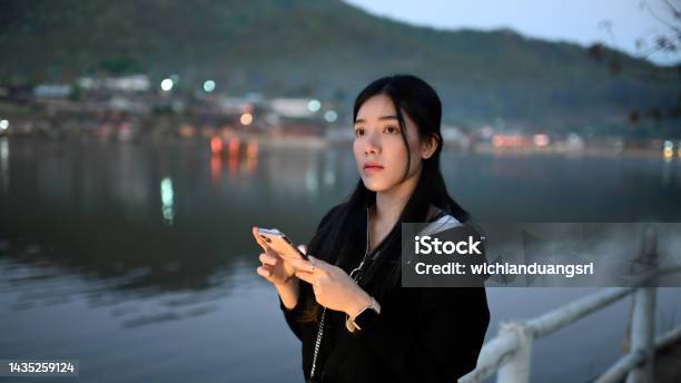 A Young Female Tourist Uses A Mobile Phone To See The Nature Stock Photo - Download Image Now