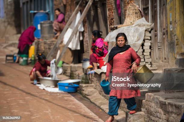 Women Wash Clothes And Dishes On The Streets In Kathmandu Nepal Stock Photo - Download Image Now