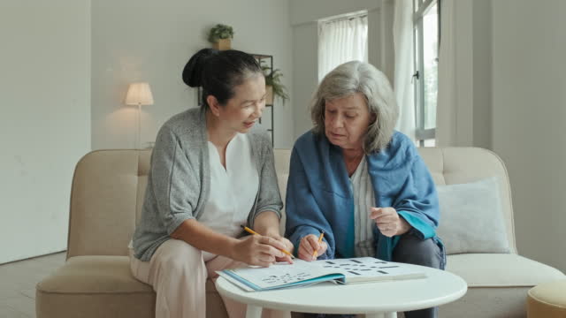 Elderly Women Having Fun while Solving Crossword