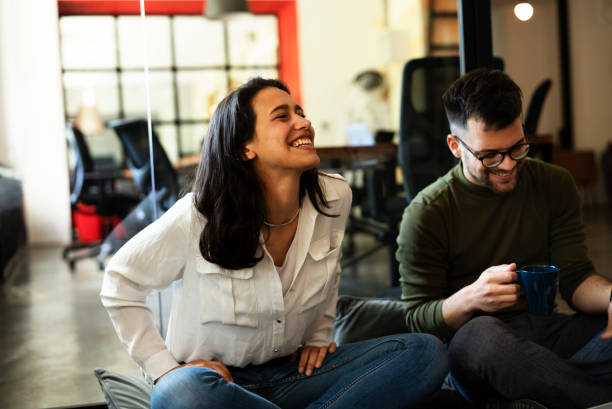 istock Colleagues sitting on the floor in office. 1435264842