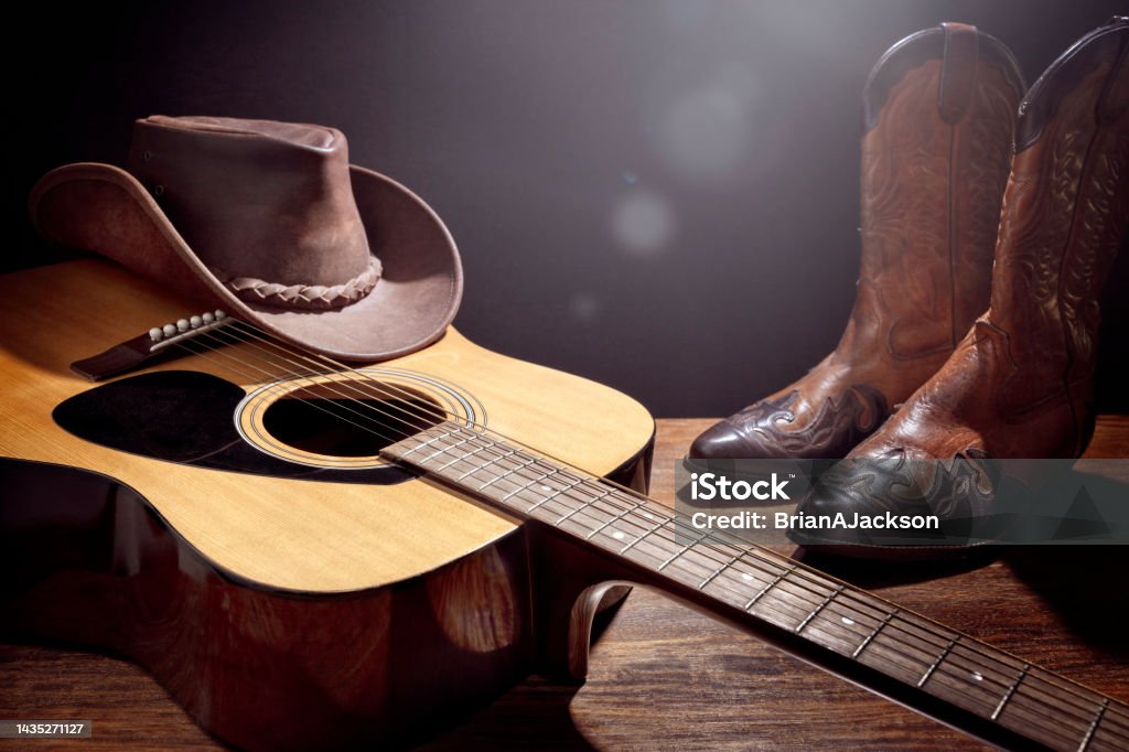 Country music festival live concert with acoustic guitar, cowboy hat and boots Country music festival live concert with acoustic guitar, cowboy hat and boots background Country and Western Music Stock Photo