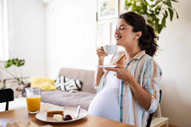 istock Young pregnant woman drinking coffee enjoying a breakfast 1435271634