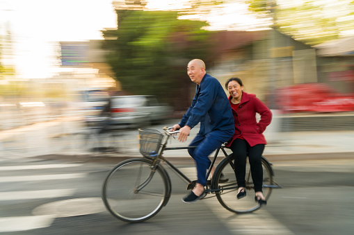 Older couple on bicycle, Beijing, China