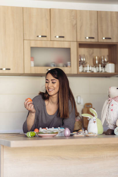 istock Traditional young woman posing with colored eggs 1435280489