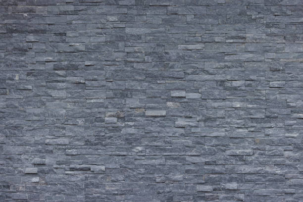 istock seamless stone wall background and texture. rock wall panel decoration for exterior and interior house. 1435282836