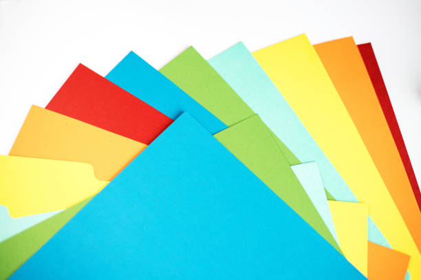 istock Colored sheets of paper superimposed on each other on white background. 1435284207
