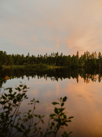 Beautiful lake at sunset in Sweden\ncalm water in pastel