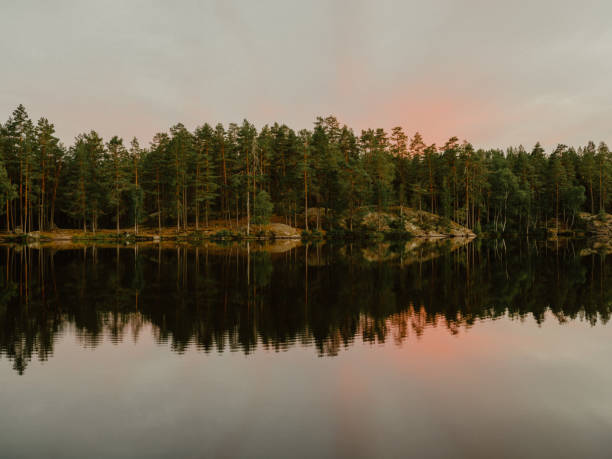 Beautiful lake at sunset in Sweden\ncalm water in pastel