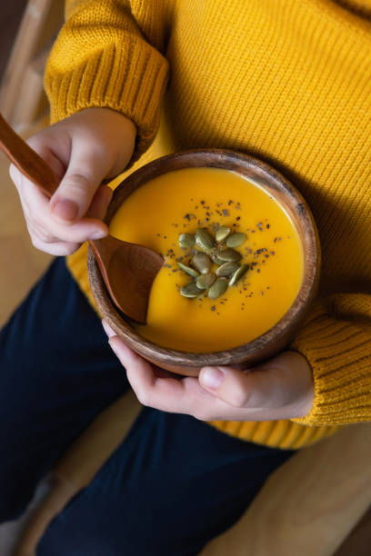 istock Child eating pumpkin cream soup 1435288162