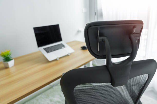 istock Ergonomic chair and Adjustable table with laptop computer in modern workplace. Good posture to avoid Office syndrome, Back Pain, shoulder ache, fibromyalgia and Neck pain 1435289221