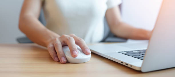 istock Woman using mouse and laptop computer during working long time on workplace. Wrist pain, De Quervain s tenosynovitis, Ergonomic, Carpal Tunnel Syndrome or Office syndrome concept 1435289301