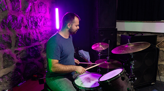 Caucasian ethnicity Young adult man playing drums