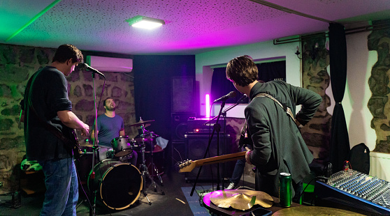 Music band having a rehearsal in studio