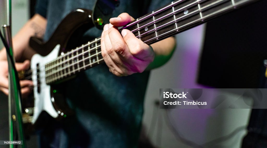 Unrecognizable male playing bass guitar Bass Guitar Stock Photo